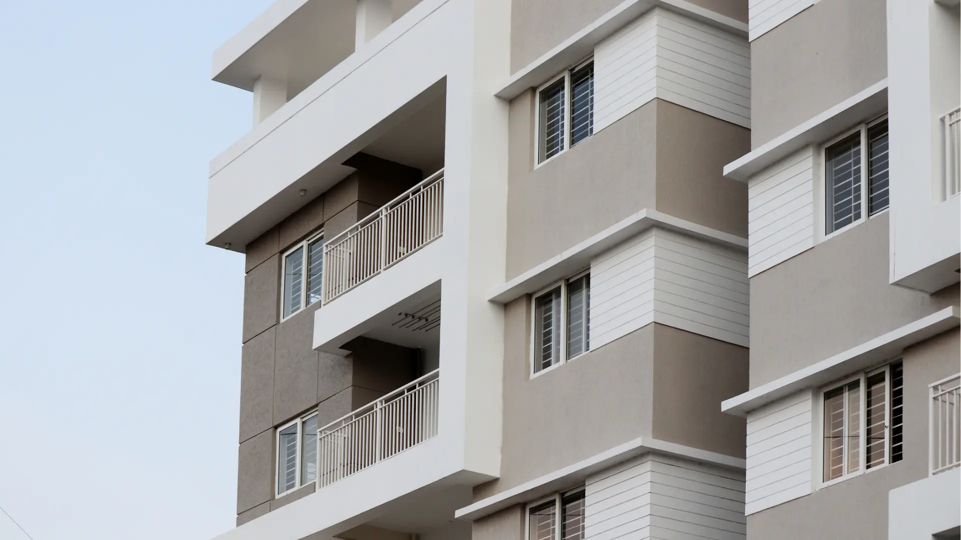 Experience a stunning multi-unit property transformation in Abbotsford with this modern apartment building. Boasting balconies and large windows, it features elegant white and beige exterior panels that perfectly complement its contemporary design.